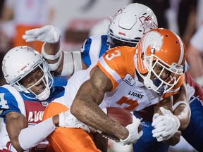 BC Lions' Ricky Collins Jr., is tackled by Montreal Alouettes' T.J. Heath during first half CFL football action in Montreal, Friday, Sept. 14, 2018.