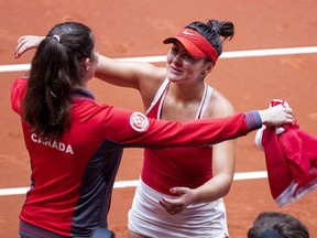 Canada's Bianca Andreescu celebrates with a teammate after winning her Fed Cup World Group II match against Netherlands' Arantxa Rus on February 10, 2019. (Koen Suyk / ANP / AFP)