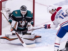 Ducks goalie Chad Johnson makes a save while Canadiens rookie Jesperi Kotkaniemi looks for the rebound during first period Tuesday night at the Bell Centre.