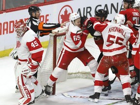 Detroit Red Wings goaltender Jonathan Bernier skates away from a skirmish in front of his net between teammate Danny DeKeyser and the Ottawa Senators' Mark Borowiecki  during the third period.