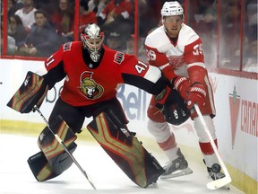 Senators goaltender Craig Anderson (41) battles for the puck behind his net against Red Wings forward Anthony Mantha during Saturday's game at Canadian Tire Centre.