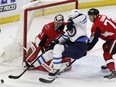 Ottawa Senators Thomas Chabot (72) knocks down Winnipeg Jets Patrik Laine (29) as he tries to score on Senators goaltender Craig Anderson (41) during second period NHL hockey action at the Canadian Tire Centre in Ottawa on Monday, April 2, 2018.