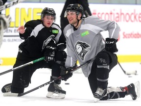 Gerard Keane and Cole Tymkin of the Knights chat as they watch a drill during practice at the Western Fair Sports Centre on Thursday. Mike Hensen/The London Free Press/Postmedia Network