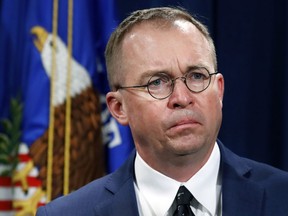 In this July 11, 2018, file photo Mick Mulvaney, acting director of the Consumer Financial Protection Bureau (CFPB), and Director of the Office of Management, listens during a news conference at the Department of Justice in Washington.