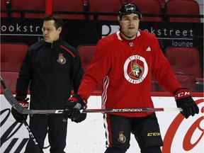 Ottawa Senators coach Guy Boucher and Cody Ceci during practice.