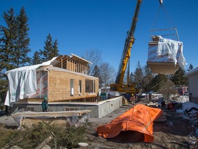 The second of two modules built by Guildcrest Homes is lifted by a 90 ton crane and set down on a basement foundation. Aside from being rapidly installed which is great for infill lots as it minimizes the disturbance in the neighborhood; modular homes offer the advantage of having been built in a factory environment protected from the outside cold, snow and/or wet rain.