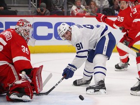 Toronto Maple Leafs' John Tavares can't gain control of the puck in front of Jimmy Howard of the Detroit Red Wings during the first period at Little Caesars Arena on Feb. 1, 2019 in Detroit.