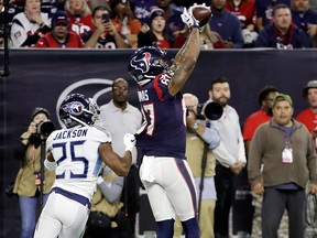Houston Texans wide receiver Demaryius Thomas pulls in a 12-yard pass for a touchdown over Tennessee Titans cornerback Adoree' Jackson during the first half of an NFL game, Monday, Nov. 26, 2018, in Houston.