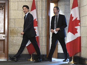 Prime Minister Justin Trudeau leaves his office with his principal secretary, Gerald Butts, to attend an emergency cabinet meeting on Parliament Hill in Ottawa on Tuesday, April 10, 2018. (THE CANADIAN PRESS/Justin Tang)