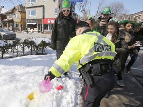 Police confiscate alcohol at a St. Patrick's Day party on Russell Avenue in the Sandy Hill Neigbourhood of Ottawa on Saturday, March 17, 2018.