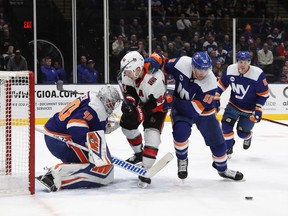 Islanders goalie Robin Lehner and defenceman Johnny Boychuk (55) defend against Senators centre Jean-Gabriel Pageau during the first period of Tuesday's game.