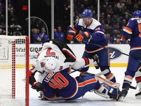 Brady Tkachuk #7 of the Ottawa Senators is runs over Robin Lehner  of the New York Islanders as the Senators tie the score at 4-4 in the third period at NYCB Live's Nassau Coliseum on Tuesday night. (Bruce Bennett/Getty Images)
