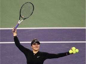 Bianca Andreescu hits autographed balls into the crowd after her women's singles semifinal match victory against Elina Svitolina in the BNP Paribas Open late Friday night.