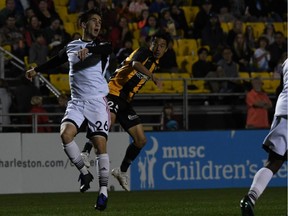 Thomas Meilleur-Giguère, left, of Ottawa Fury FC jostles with Kotaro Higashi of the Charleston Battery during a United Soccer League game at Charleston, S.C., on Saturday, March 9, 2019. The game ended in a 1-1 draw.