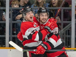 Kyle Maksimovich, right, celebrates a goal by teammate Tye Felhaber, left, during a regular-season game on March 3. Maksimovich's two goals against the Bulldogs on Friday night ended an 11-game scoring drought for the overage forward.