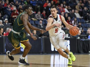 Carleton's Isiah Osborne, right, drives past Alberta's Dwan Williams during the first half of Friday's game in Halifax.