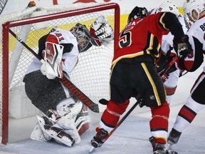Ottawa Senators goalie Craig Anderson is pushed into the net as the Calgary Flames' Mark Giordano scores during the first period on Thursday, March 21, 2019.