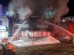 Firefighters battle a blaze at Allium restaurant on Holland Avenue on March 1, 2019.