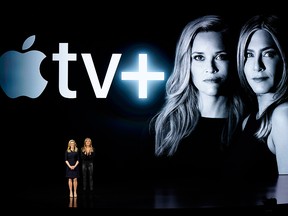 Reese Witherspoon, left, and Jennifer Aniston speak at the Steve Jobs Theater during an event to announce new Apple products Monday, March 25, 2019, in Cupertino, Calif.