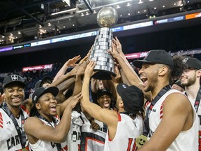 Members of the Carleton Ravens celebrate winning the USports men's basketball national championship over the University of Calgary Dinos in Halifax on Sunday, March 10, 2019.
