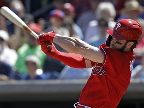 The Philadelphia Phillies' Bryce Harper swings at a pitch from the Toronto Blue Jays' Matt Shoemaker during the first inning of a spring training baseball game Saturday, March 9, 2019, in Clearwater, Fla.