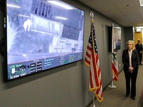Sacramento County District Attorney Anne Marie Schubert displays a video from a Sacramento County Sheriff's helicopter in last year's fatal shooting of an unarmed black man, during a news conference in Sacramento, Calif., Saturday, March 2, 2019.