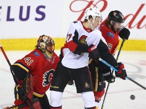 Senators Brady Tkachuk and Flames Elias Lindstrom battle in front of Flames netminder Mike Smith during NHL action between the Ottawa Senators and the Calgary Flames in Calgary on Thursday, March 21, 2019.