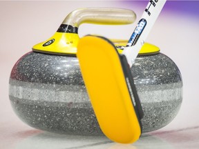 A stock image of a curling stone and brush.