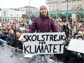 Swedish climate activist Greta Thunberg holds a protest poster as she attends a protest rally in Hamburg, Germany, on Friday, March 1, 2019. The slogan reads 'School Strike For The Climate'.
