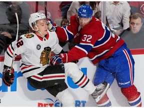 Canadiens' Christian Folin checks Chicago Blackhawks' Gustav Forsling in Montreal on Saturday, March 16, 2019.