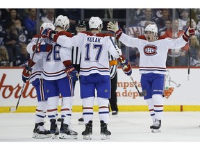 Canadiens' Andrew Shaw (65), Jeff Petry (26), Brett Kulak (17) and Artturi Lehkonen (62) celebrate Petry's goal against the Jets in Winnipeg on Saturday, March 28, 2019.