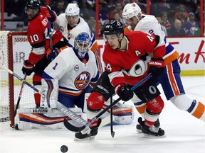 Ottawa Senators centre Jean-Gabriel Pageau (44) tries to control the puck in front of New York Islanders goaltender Thomas Greiss (1) as New York Islanders defenceman Nick Leddy (2) defends during the first period at the CTC on Thursday, March 7, 2019.