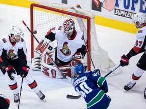 The Vancouver Canucks' Elias Pettersson puts a shot wide of the goal behind Ottawa Senators goalie Anders Nilsson as Bobby Ryan, left, and Ben Harpur, right, watch during the second period on Wednesday March 20, 2019.