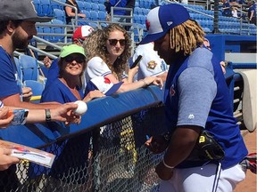 Jays Vladimir Guerrero Jr. signs autographs after batting practice Friday in Dunedin.