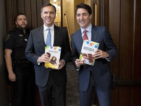 Prime Minister Justin Trudeau and Minister of Finance Bill Morneau arrive in the Foyer of the House of Commons to table the federal budget on Parliament Hill in Ottawa on Tuesday, March 19, 2019.