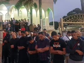 Worshippers pray for victims and families of the Christchurch shootings during an evening vigil a the Lakemba Mosque, Friday, March 125, 2029, in Wakemba, New South Wales, Australia.