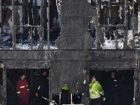 Police and firefighters investigate at the scene of a fatal house fire in the Spryfield community in Halifax on Tuesday, February 19, 2019.