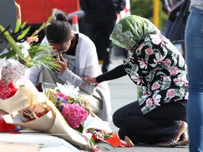 Locals lay flowers in tribute to those killed and injured at Deans Avenue near the Al Noor Mosque on March 16, 2019, in Christchurch, New Zealand. (Fiona Goodall/Getty Images)