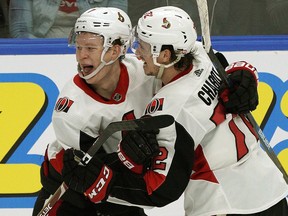 The Ottawa Senators' Brady Tkachuk (left) celebrates his overtime goal with Thomas Chabot in Edmonton on Saturday, March 23, 2019.