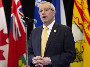 Ontario Finance Minister Vic Fedeli speaks with media following meetings with federal, provincial and territorial counterparts in Ottawa, December 10, 2018. THE CANADIAN PRESS/Adrian Wyld