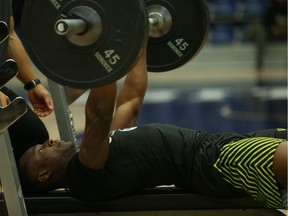 Queen's University receiver Chris Osei-Kusi participates in the bench press at the CFL Combine in Toronto on Saturday.