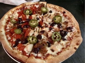 "Red six" pizza with grilled chicken, Applewood
bacon, roasted red peppers,
black olives, pickled jalapenos at Rabbit Hole,