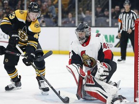 The Boston Bruins' Danton Heinen (43) tries to shoot past the Ottawa Senators' Craig Anderson (41) during the second period of an NHL hockey game in Boston, Saturday, March 9, 2019.