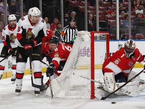 Ottawa Senators’ Cody Ceci (left) passes the puck out in front of Panthers goaltender Roberto Luongo at the BB&T Center in Sunrise, Fla., yesterday. The Sens won 3-2, their first victory since mid-February. (Getty images)