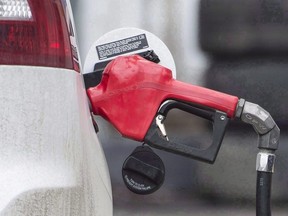 A gas pump is shown at a filling station.