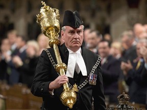 The Sergeant-at-Arms Kevin Vickers receives a standing ovation as he enters the House of Commons Thursday October 23, 2014 in Ottawa.