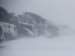 Trucks are parked in the snow at the Pilot Flying J near Interstate 90 in Rapid City, S.D., Wednesday, March 13, 2019. I-90 was closed from the Wyoming border to Oacoma, S.D., earlier in the day.