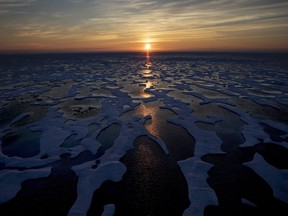 The midnight sun shines across sea ice along the Northwest Passage in the Canadian Arctic Archipelago on July 22, 2017. Canada is warming up twice as fast as the rest of the world and that warming is 'effectively irreversible', a new scientific report from Environment and Climate Change Canada says.
