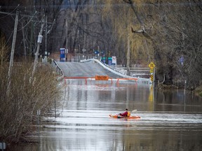 The low lying areas around Ottawa and Gatineau were hit with the beginning of the flooding near the rivers, Sunday, April 21, 2019. A paddler played in the current on what normally would be the road into Petrie Island Sunday evening.