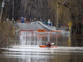 The low lying areas around Ottawa and Gatineau were hit with the beginning of the flooding near the rivers, Sunday, April 21, 2019. A paddler played in the current on what normally would be the road into Petrie Island Sunday evening.